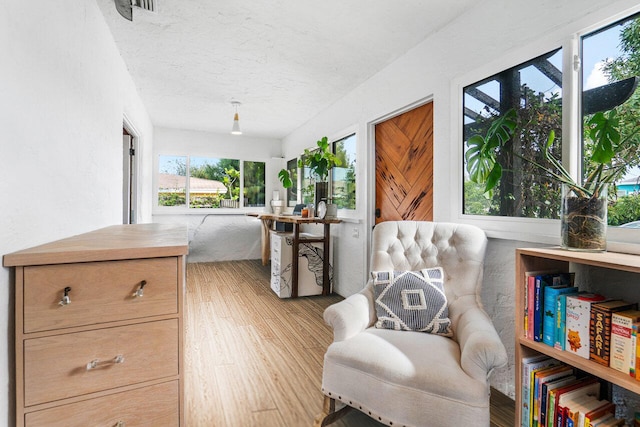 sitting room with light hardwood / wood-style floors