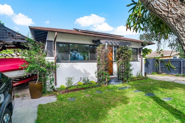 view of front facade with a front lawn and a pergola