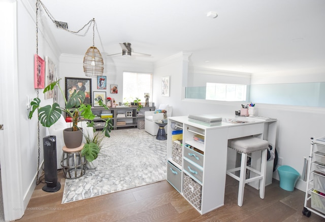 interior space with crown molding, wood-type flooring, and ceiling fan