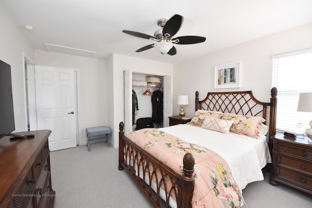 carpeted bedroom featuring a closet and ceiling fan