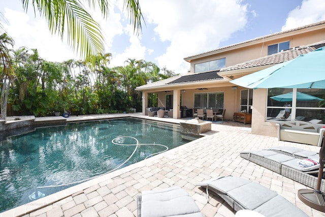 view of swimming pool with an outdoor living space, a patio, and ceiling fan