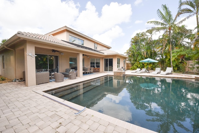 view of pool featuring an outdoor living space, a patio, and ceiling fan