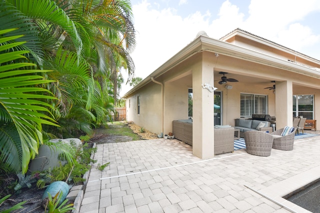 view of patio with outdoor lounge area and ceiling fan