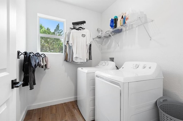 laundry room with independent washer and dryer and hardwood / wood-style floors