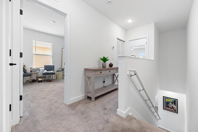 hallway with light colored carpet