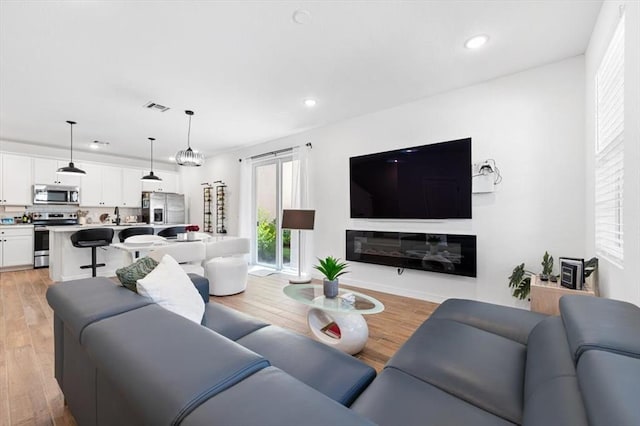 living room with light hardwood / wood-style floors