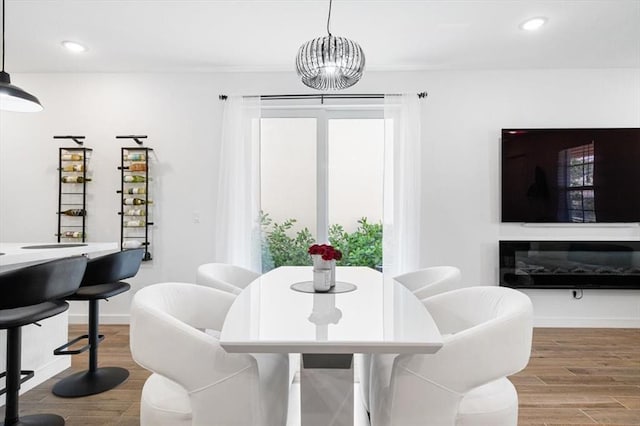 dining room with a chandelier and hardwood / wood-style flooring