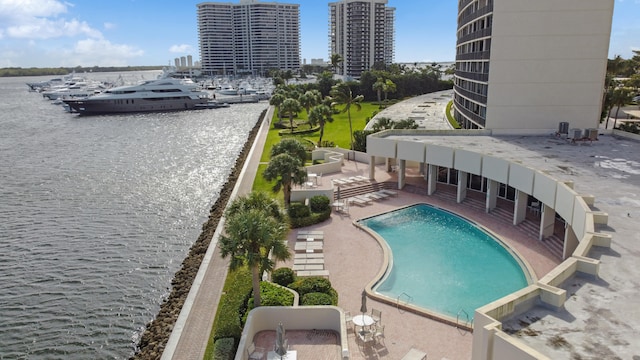 view of swimming pool with a patio and a water view