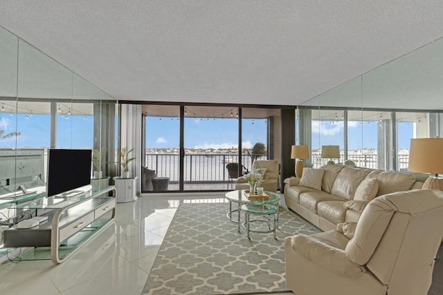 living room featuring floor to ceiling windows, light tile patterned flooring, a textured ceiling, and plenty of natural light