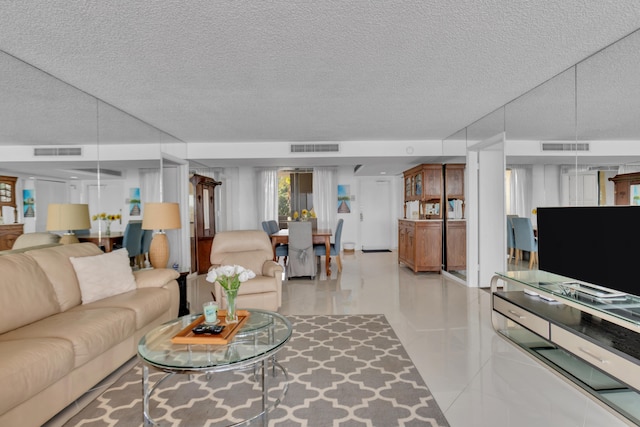 tiled living room featuring a textured ceiling