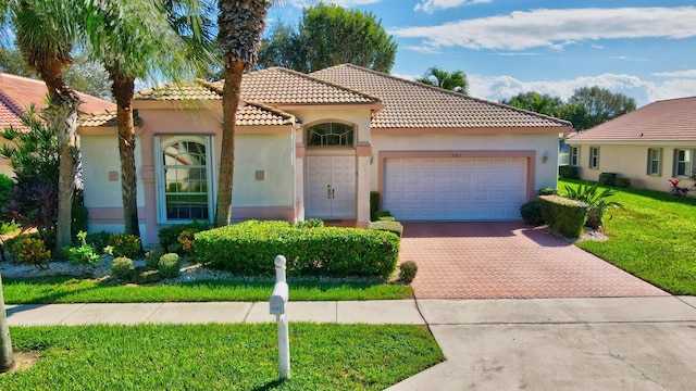 mediterranean / spanish-style home with a garage