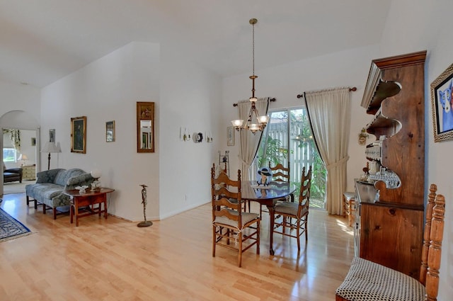 dining area with a chandelier and light hardwood / wood-style flooring