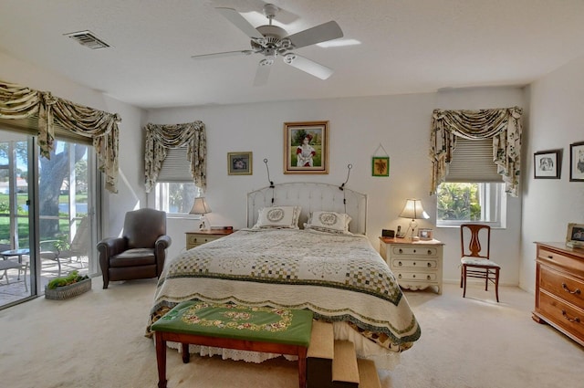 carpeted bedroom featuring ceiling fan and access to exterior