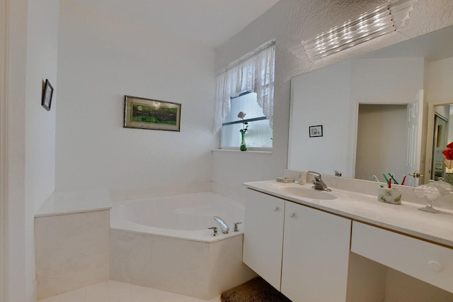 bathroom with a washtub and vanity