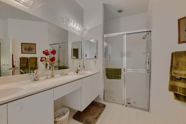 bathroom with tile patterned floors, vanity, and an enclosed shower