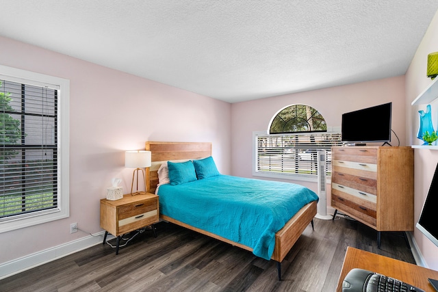 bedroom with a textured ceiling and dark hardwood / wood-style flooring