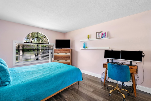 bedroom with a textured ceiling and wood-type flooring