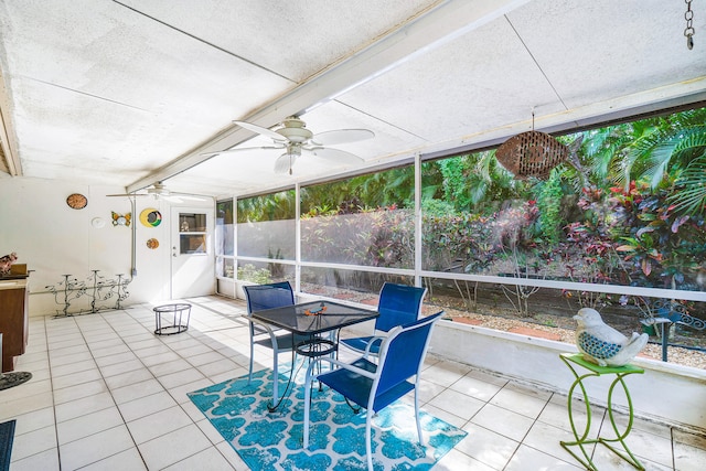 sunroom / solarium featuring ceiling fan