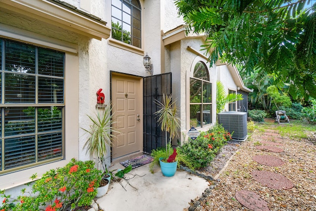 doorway to property featuring central air condition unit