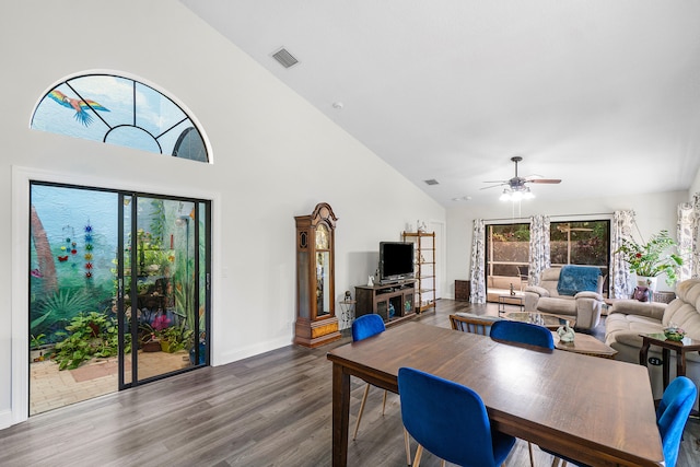 dining room featuring ceiling fan, high vaulted ceiling, and wood-type flooring