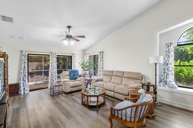 living room featuring ceiling fan, wood-type flooring, and vaulted ceiling