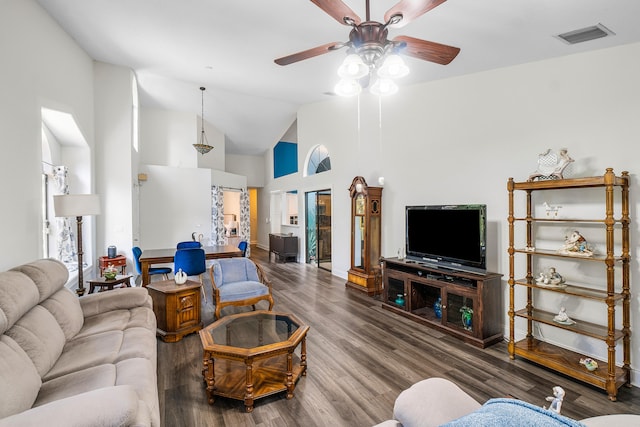 living room featuring hardwood / wood-style floors, high vaulted ceiling, and ceiling fan