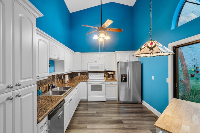 kitchen featuring sink, white cabinets, stainless steel appliances, and high vaulted ceiling