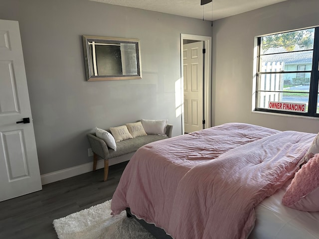 bedroom with dark hardwood / wood-style flooring