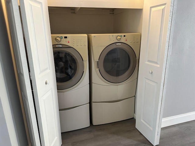 laundry area with dark hardwood / wood-style floors and independent washer and dryer