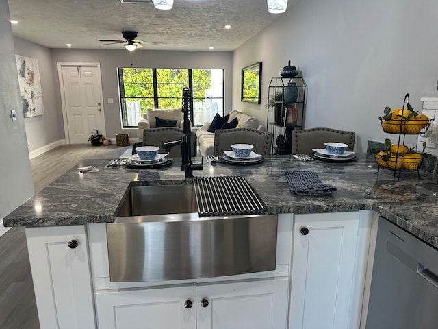 kitchen featuring white cabinets, a textured ceiling, hardwood / wood-style flooring, and ceiling fan