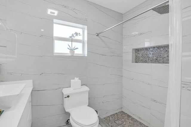 bathroom with a marble finish shower, visible vents, and toilet