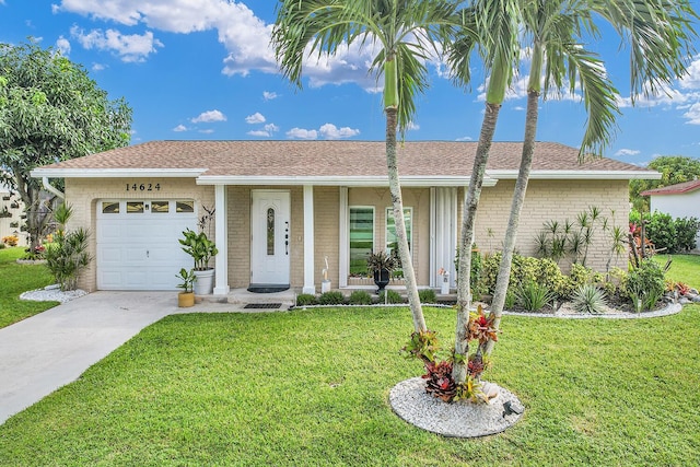 single story home featuring concrete driveway, brick siding, an attached garage, and a front lawn