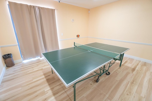 game room featuring light wood-type flooring and baseboards