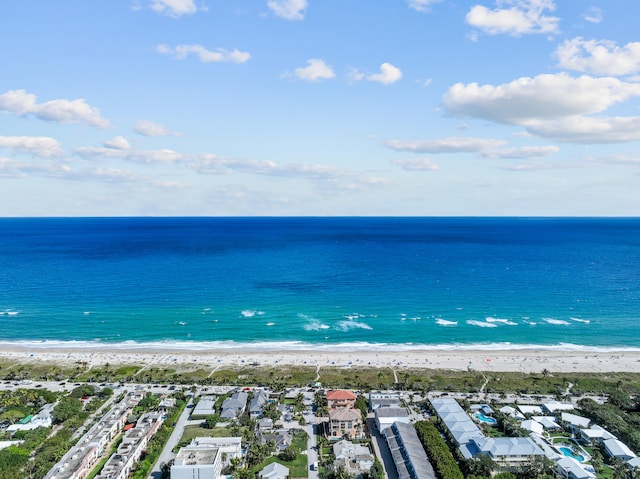 drone / aerial view featuring a beach view and a water view