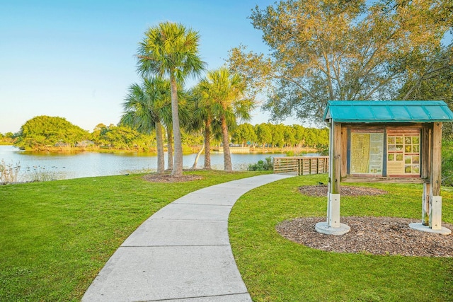 view of community featuring a water view and a lawn