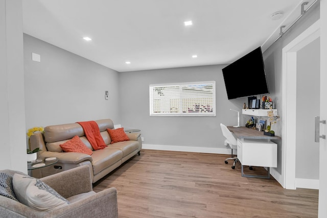 living area featuring light wood-style floors, recessed lighting, and baseboards