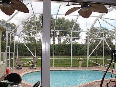 view of pool with a patio, ceiling fan, and a lanai