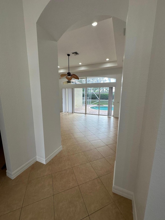 hall with light tile patterned floors