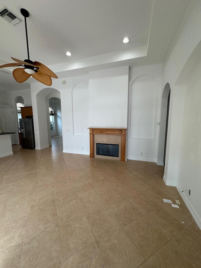 unfurnished living room with ceiling fan and light tile patterned flooring