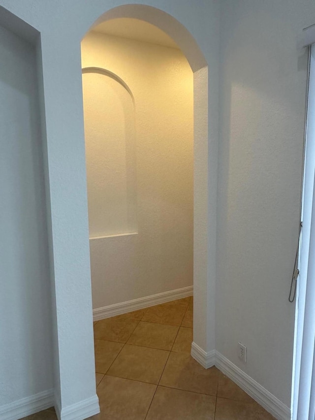 hallway with light tile patterned flooring