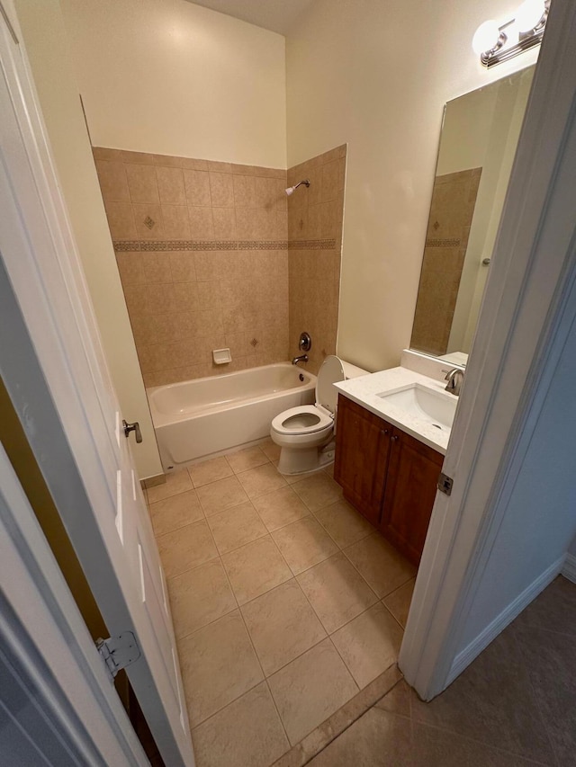 full bathroom featuring tile patterned floors, vanity, toilet, and tiled shower / bath