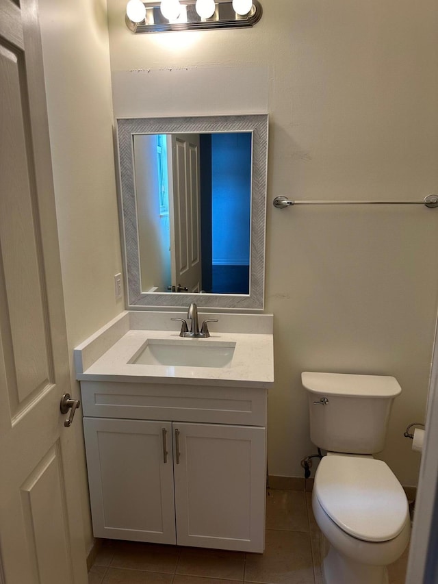 bathroom featuring tile patterned floors, vanity, and toilet