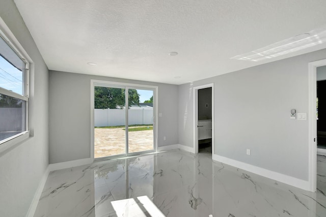 empty room with a textured ceiling