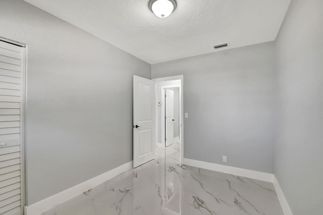 empty room with a textured ceiling