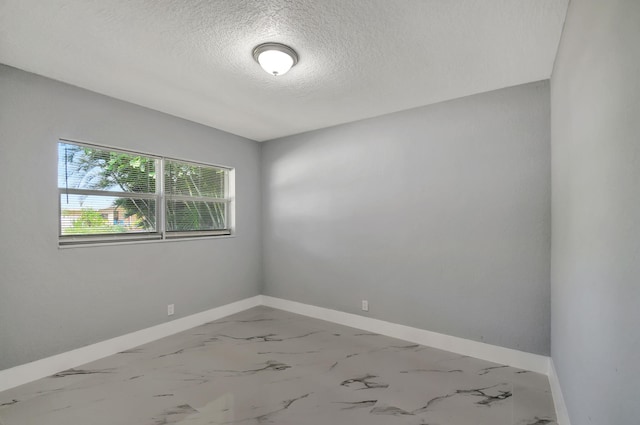 spare room with a textured ceiling