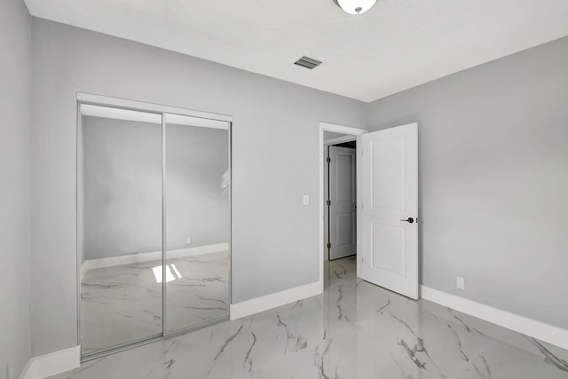 unfurnished bedroom with a closet and a textured ceiling