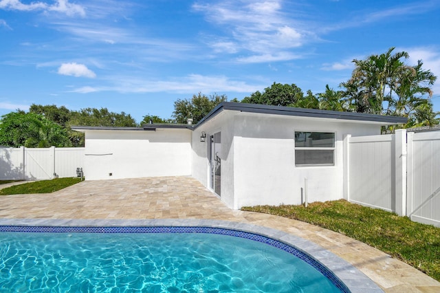 view of swimming pool with a patio area