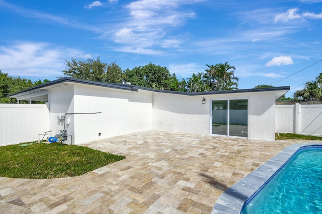 back of house with a patio and a fenced in pool