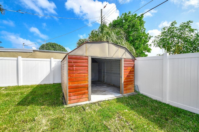 view of outbuilding featuring a yard