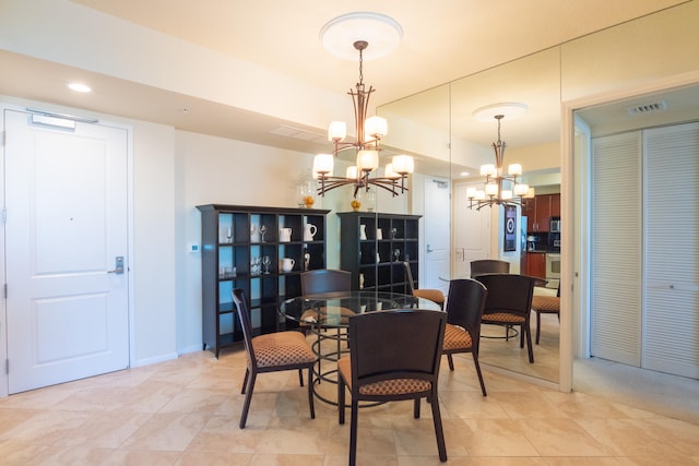 tiled dining area featuring an inviting chandelier